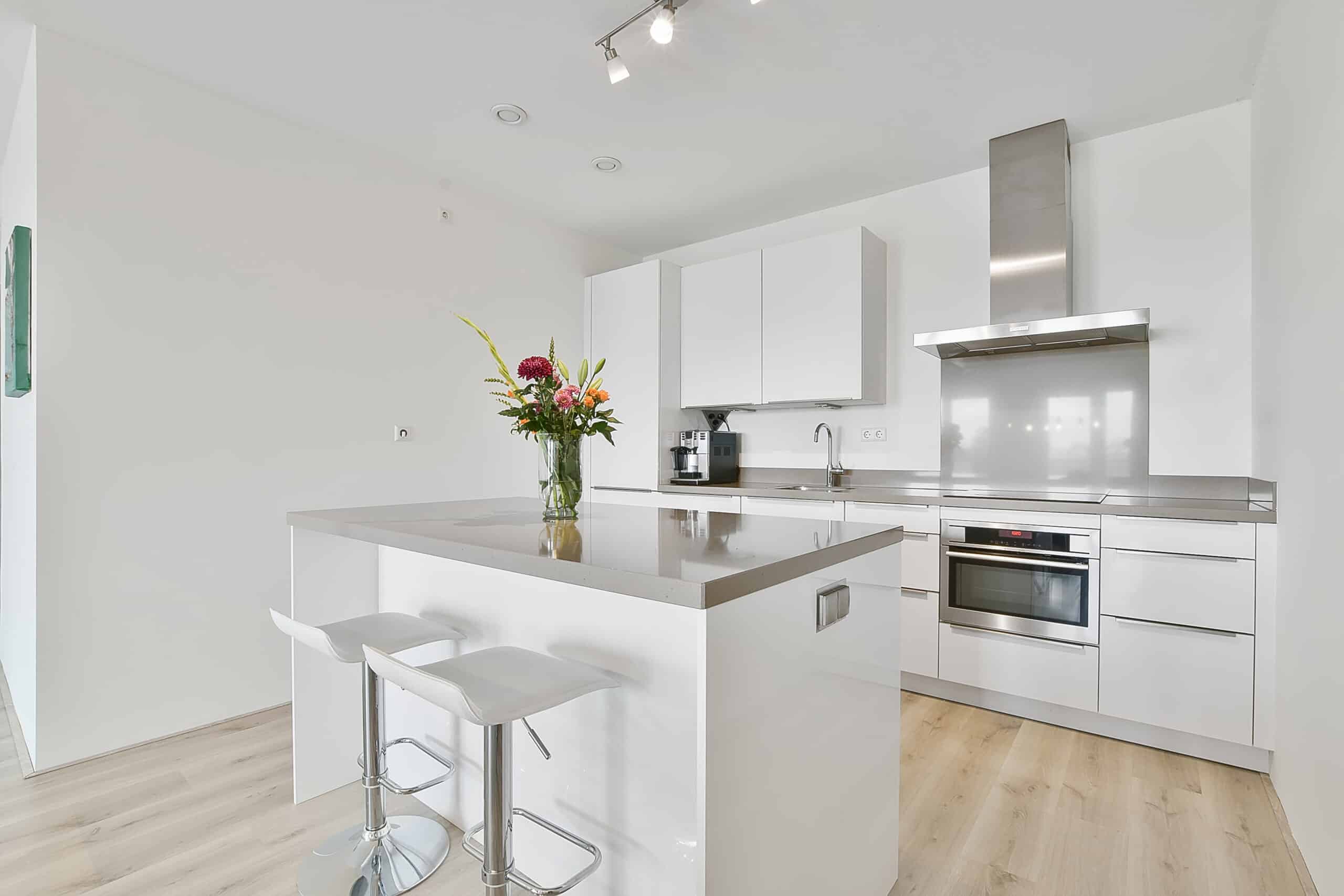 A bright kitchen in an elegant house white kitchen island